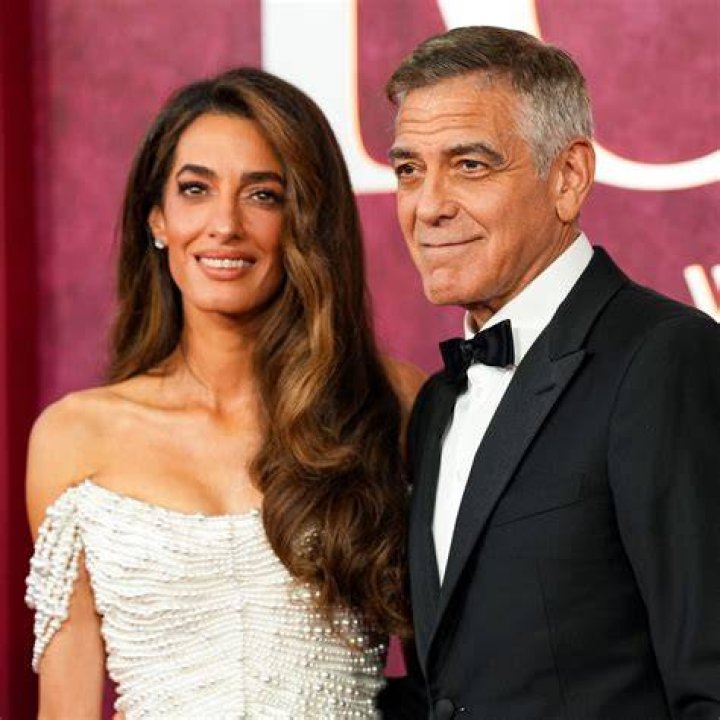 Clooney and Amal Clooney Hold Hands as They Leave Venice After