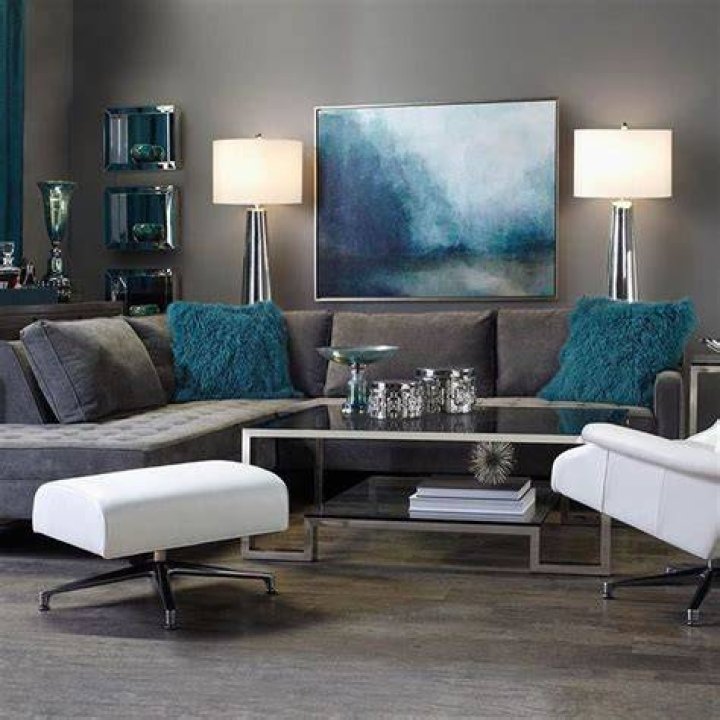Lounge sophisticatedly in gray and chrome tones with pops of calming